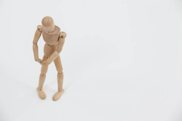 istock Wooden figurine standing with hands on knee 649583280