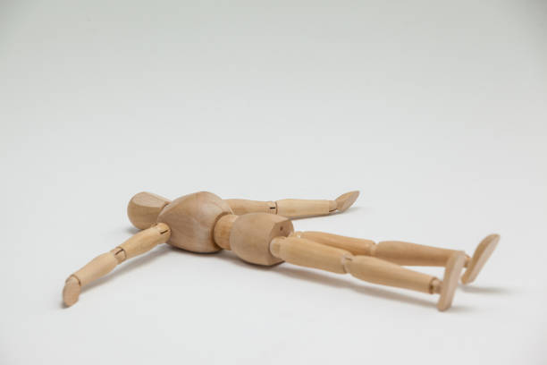 istock Wooden figurine lying on floor with arms spread 649583398