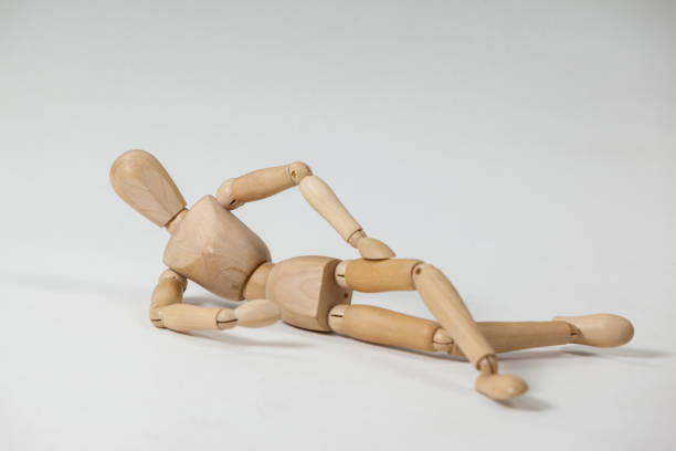 istock Wooden figurine reclining on the floor 649583474
