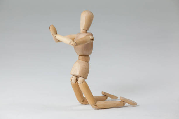istock Wooden figurine kneeling with both hands joined 649584278