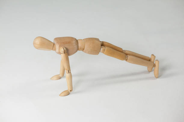 istock Wooden figurine performing push-ups 649584440