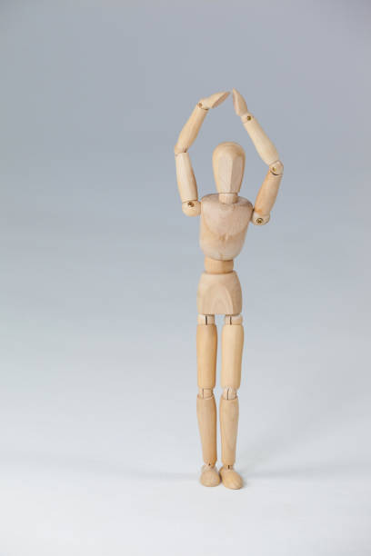 istock Wooden figurine standing with hands raised 649584486