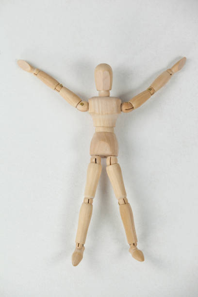 istock Wooden figurine lying on floor with arms spread wide 649587348