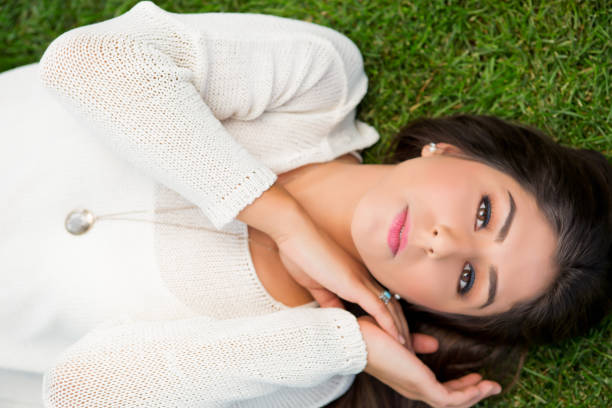 istock Young woman lying on grass 649589742
