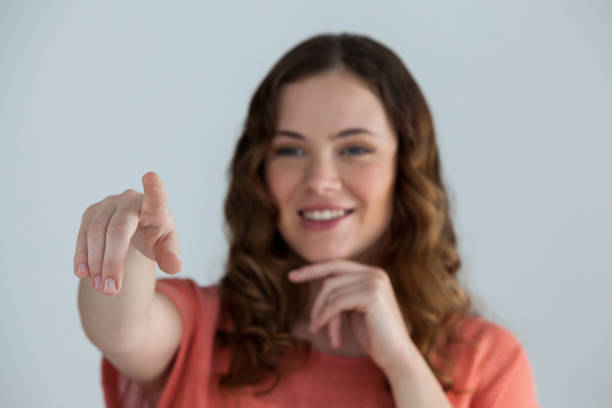 istock Woman pretending to touch an invisible screen 649590638