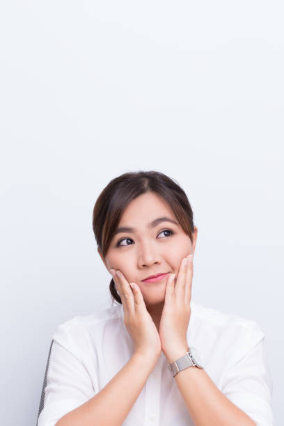istock Asian woman pointing to the copy space isolated 649590736