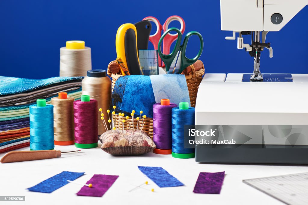 Sewing Accessories In A Basket And Spools Of Threads Next To Sewing Machine  Stock Photo - Download Image Now - iStock