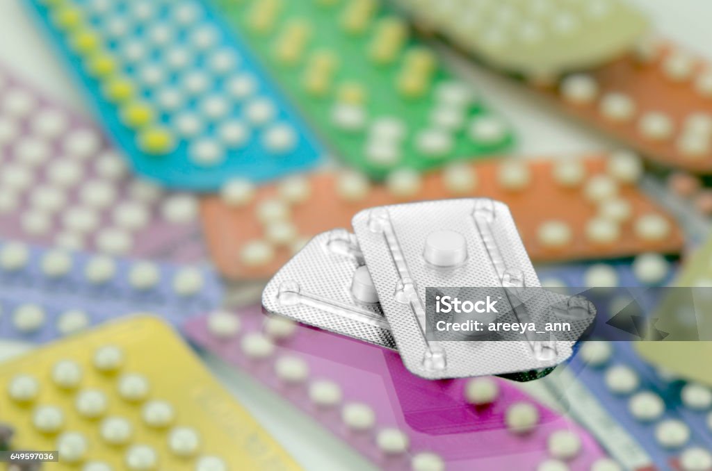 Emergency contraceptive pills. Emergency contraceptive pills on pharmacy counter with colorful pills strips background. Morning After Pill Stock Photo