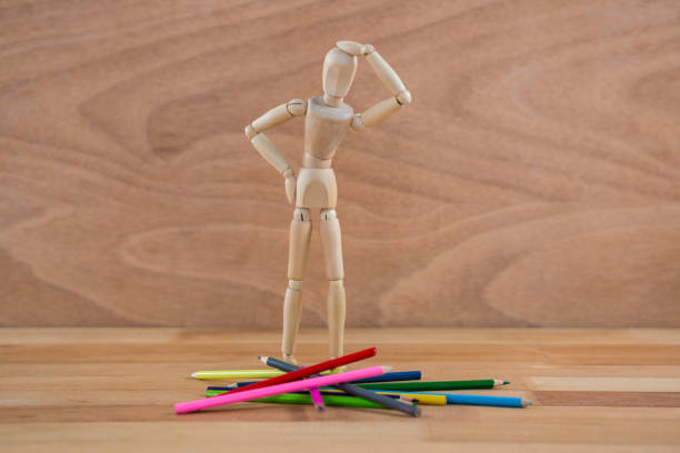 istock Wooden figurine selecting colour pencil 649597776