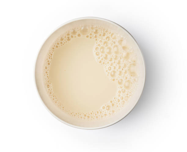 Cup with soy milk bubble foam on white background