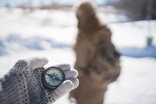 Compass in the explorer's hand.