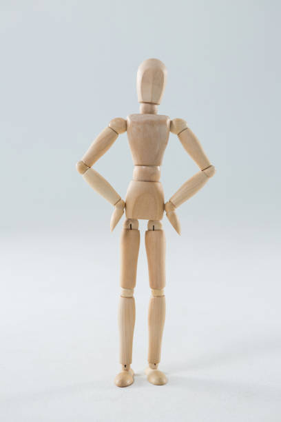 istock Wooden figurine standing with hands on hip 649597898