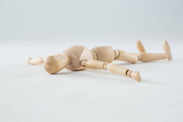 istock Wooden figurine lying on floor 649600928