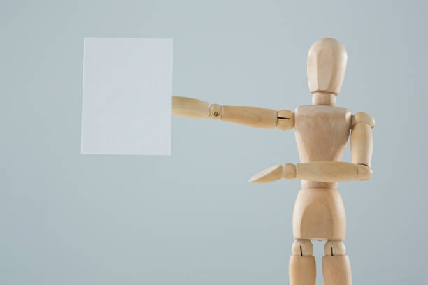 istock Wooden figurine showing blank placard 649601126