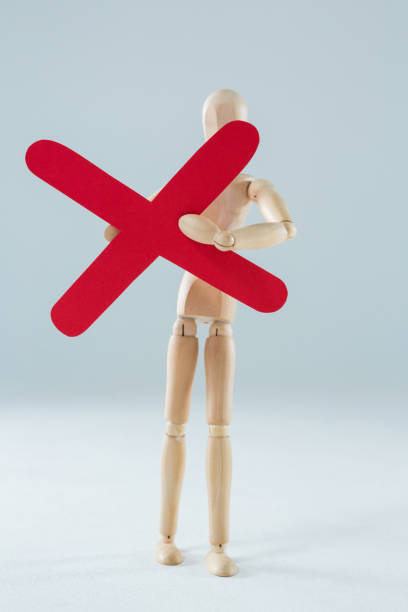 istock Wooden figurine holding multiplication sign 649601304