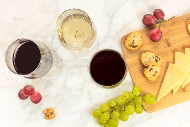 istock White and red wine with cheese, bread and grapes 649608596