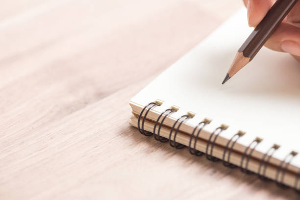 hands writing on notebook - human hand pencil women sketching imagens e fotografias de stock