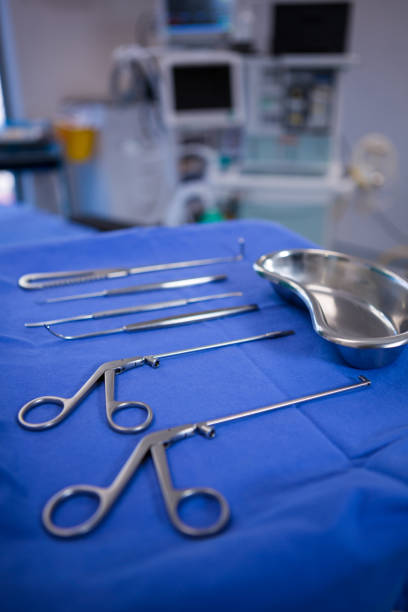 Professional dental instruments arranged on a plastic-covered tray. Stainless steel tools used in clinical dentistry for treatment and examination.