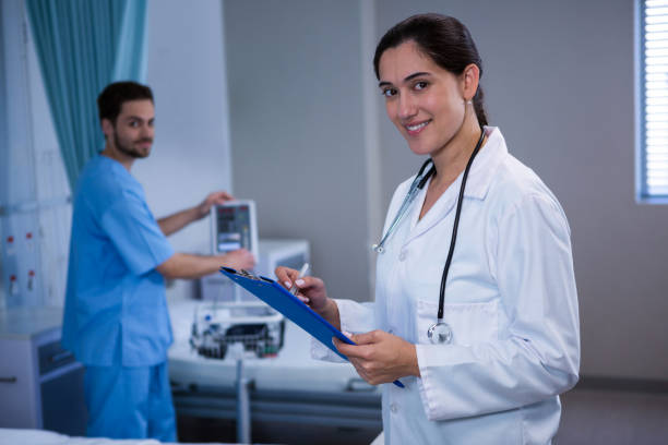 istock Portrait of doctor writing on clipboard 649612088