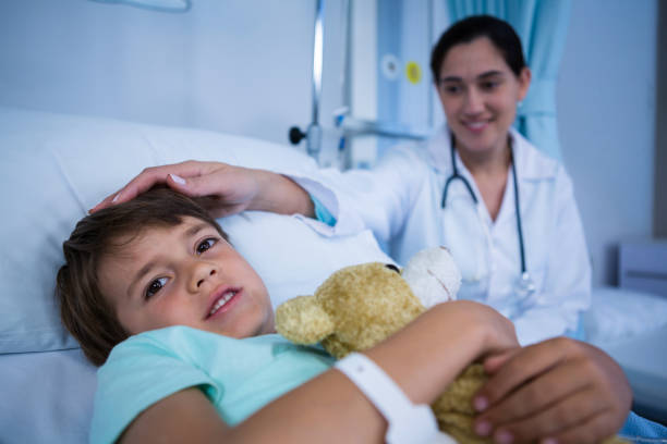 istock Doctor consoling patient during visit in ward 649615486