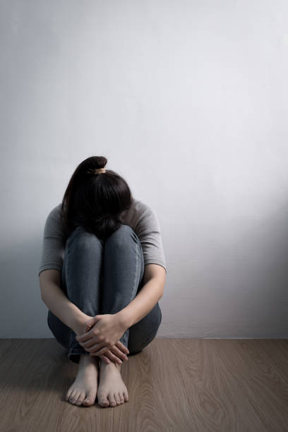 istock depression woman sit on floor 649618766