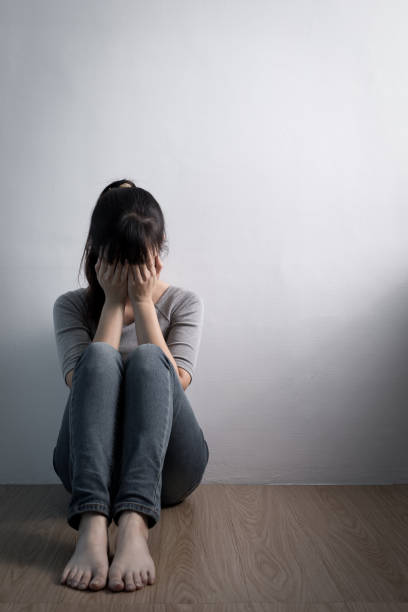 istock depression woman sit on floor 649618820