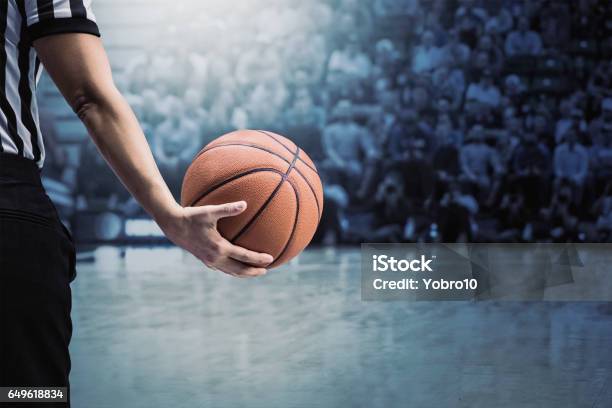 Basketball Referee Holding Ball At A Basketball Game During A Timeout Stock Photo - Download Image Now