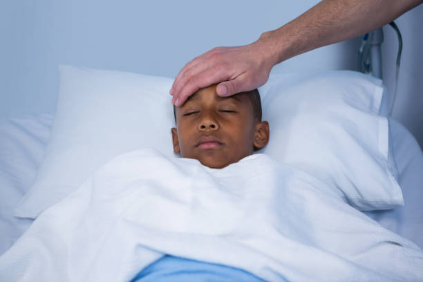 istock Male nurse checking patient fever in ward 649618972