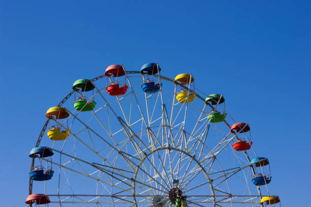 istock Empty lonely children's park roundabout against the blue sky landscape 649622278
