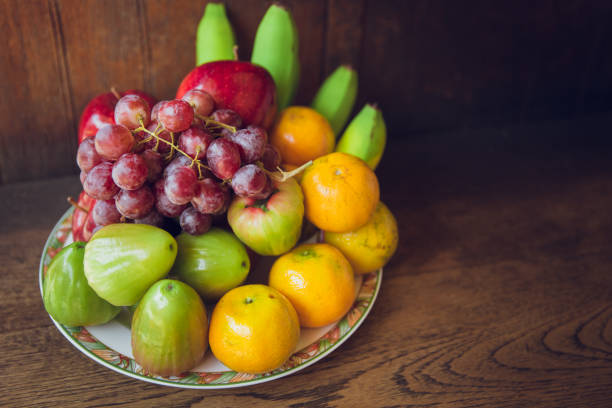 istock mix asian fruit on wood background for Chinese new year. 649622918