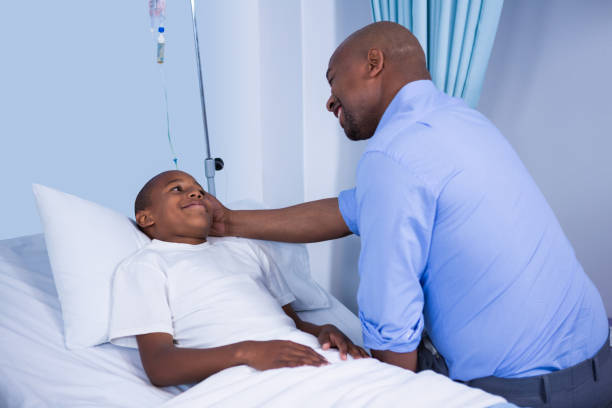 istock Male doctor consoling patient during visit in ward 649622924
