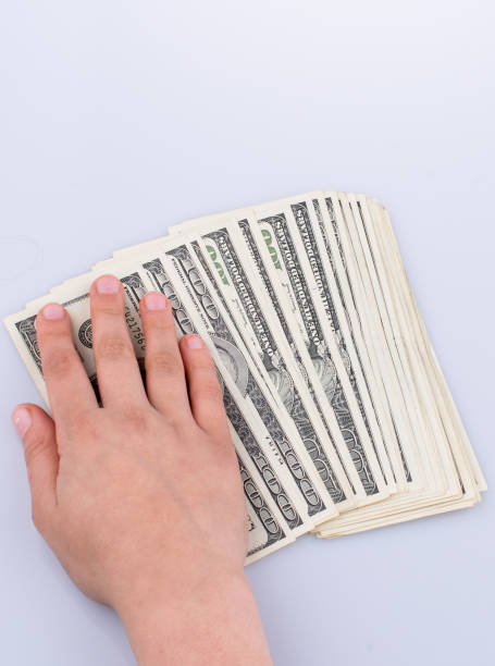 istock Human hand holding American dollar banknotes on white background 649625732