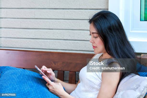 Asian Woman Typing Text Messages On Smart Phone Stock Photo - Download Image Now - Adult, Adults Only, Asian and Indian Ethnicities