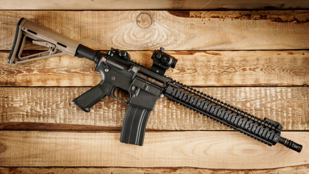 istock assault rifle on a wooden table 649643170