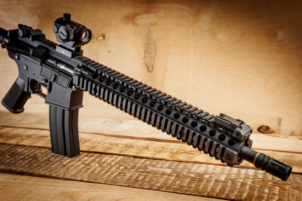 istock assault rifle on a wooden table 649643352