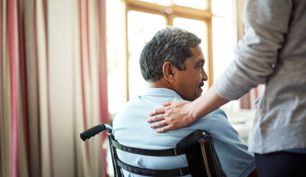 Comfort and care will always be near Shot of a young nurse caring for a senior man in a retirement home hand on shoulder photos stock pictures, royalty-free photos & images
