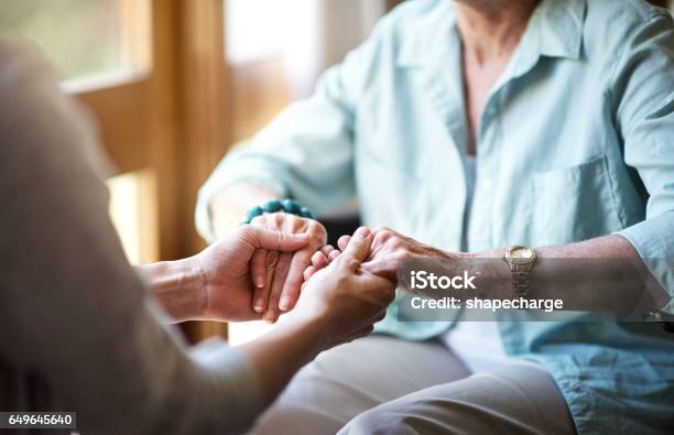 Reaching Out In Comfort And Support Stock Photo - Download Image Now - Senior Adult, Hand, Community Outreach