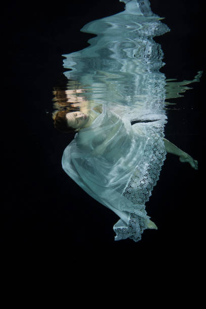 istock Pregnant woman swimming underwater 649646580