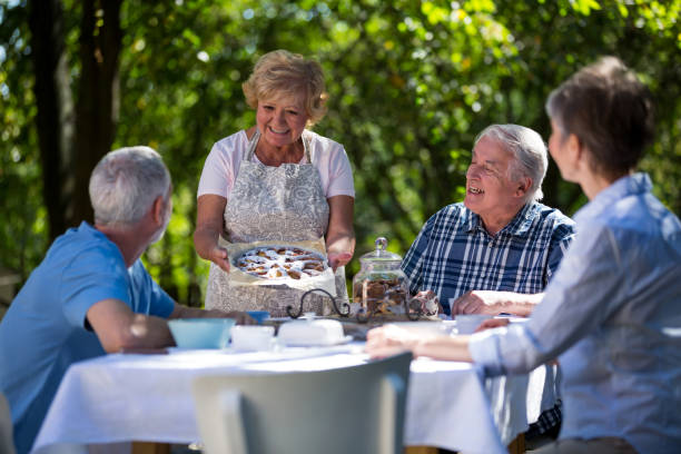 istock Senior couples having breakfast in garden 649649552