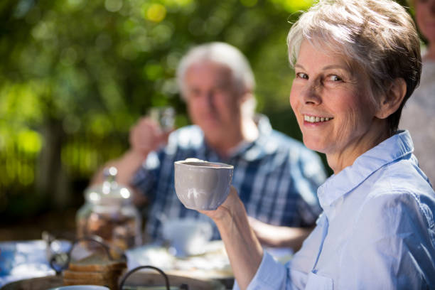 istock Senior couples having breakfast in garden 649649686