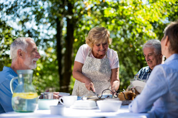 istock Senior couples having breakfast in garden 649649728