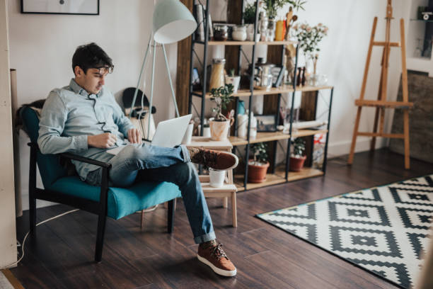 istock Young man resting at his house and using laptop 649650400