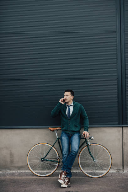 istock Hipster man with bicycle and smart phone 649654132
