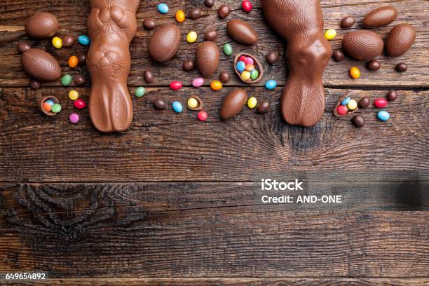 Chocolate Easter Bunny And Eggs On Wooden Background Stock Photo - Download Image Now