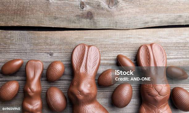 Chocolate Easter Bunny And Eggs On Wooden Background Stock Photo - Download Image Now