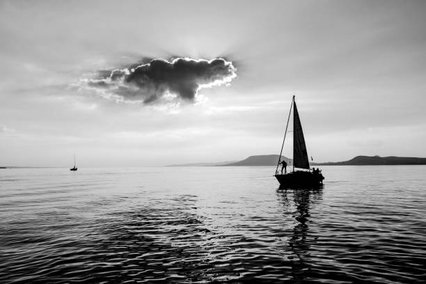 istock A little boat is sailing on the water with captain on board 649661848