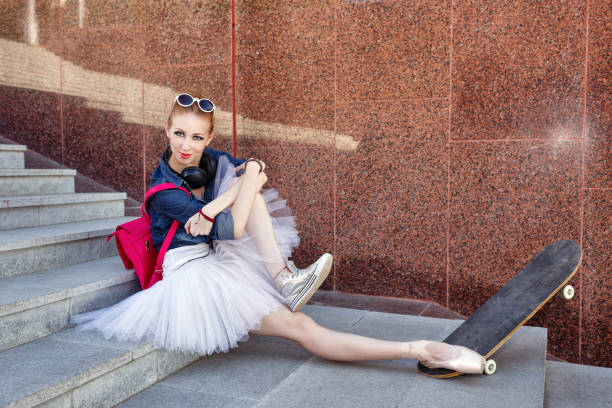 istock Ballerina hipster sits on the steps. 649664680