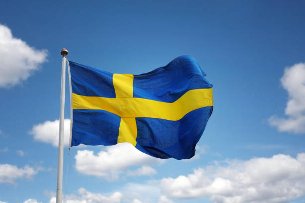 Swedish flag Swedish flag against blue sky sweden flag stock pictures, royalty-free photos & images