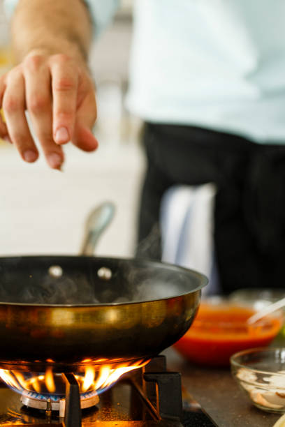 istock Frying pan on gas stove 649665750