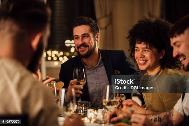 Socialising Over A Meal Stock Photo - Download Image Now - Dinner, Restaurant, Friendship